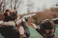 Students aiming pistols at targets during defensive pistol training